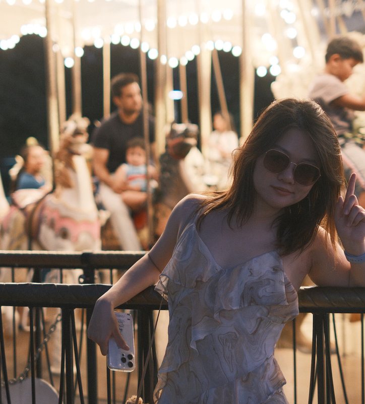 Ziyi at a night-time carousel